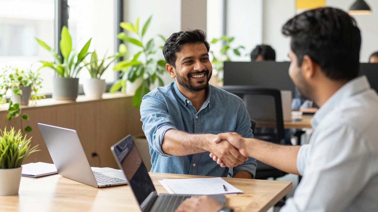 Two colleagues shaking hands in a bright, plant-filled co-working space